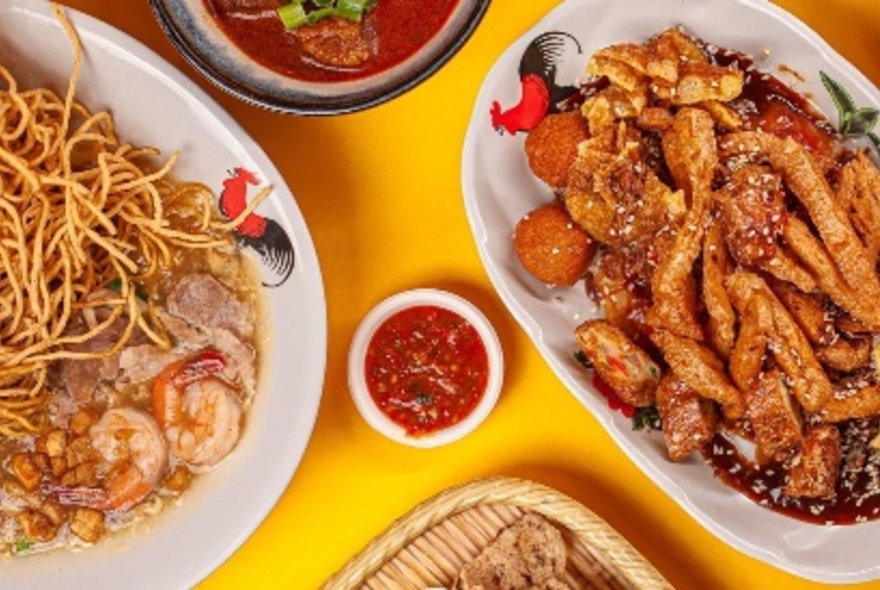 Overhead views of plates of food on a yellow table.