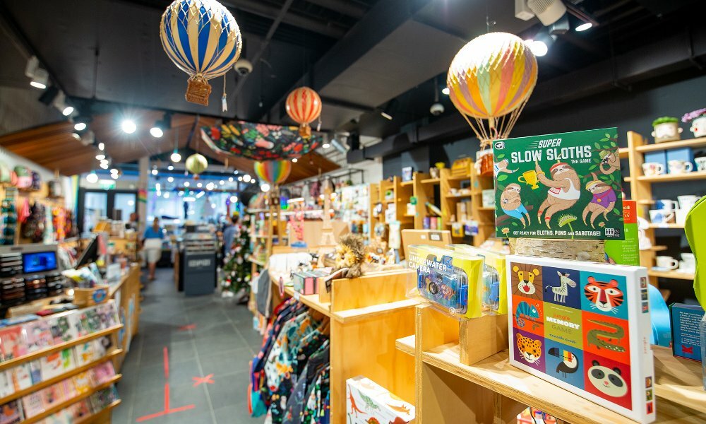 A kids toy shop with hot air balloons hanging from the ceiling.