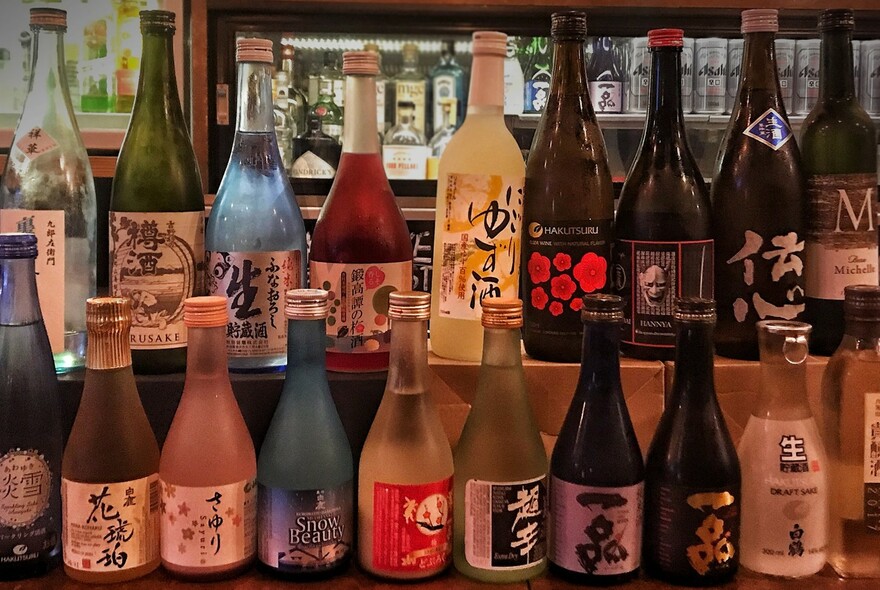 Large selection of Japanese sake bottles.