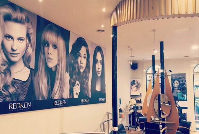 Interior of Accent Hair and Beauty showing posters of women on the wall. 