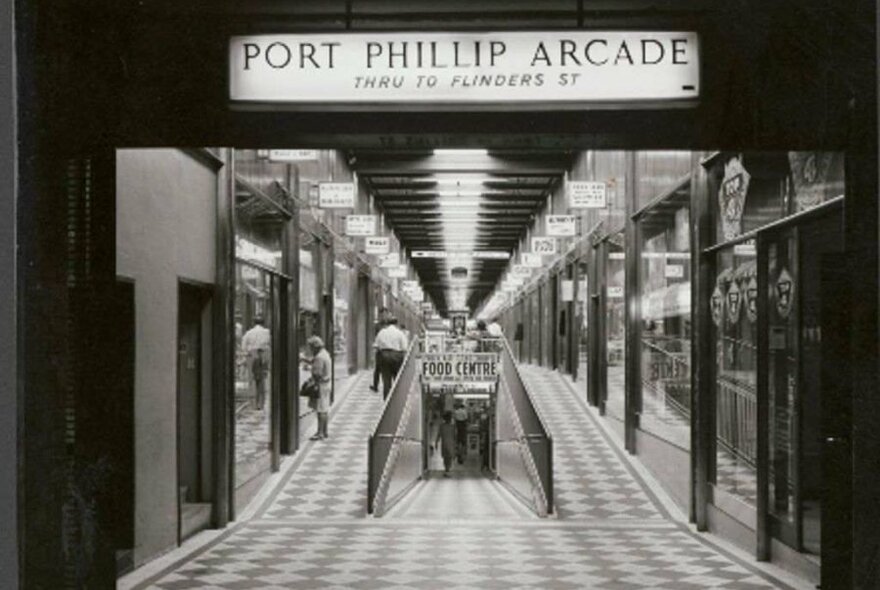 A black and white photo of an old arcade 