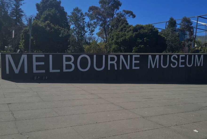 Exterior of Melbourne Museum plaza with signage.