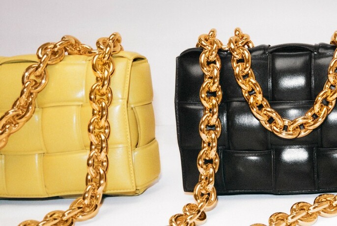 Two handbags with gold chain straps.
