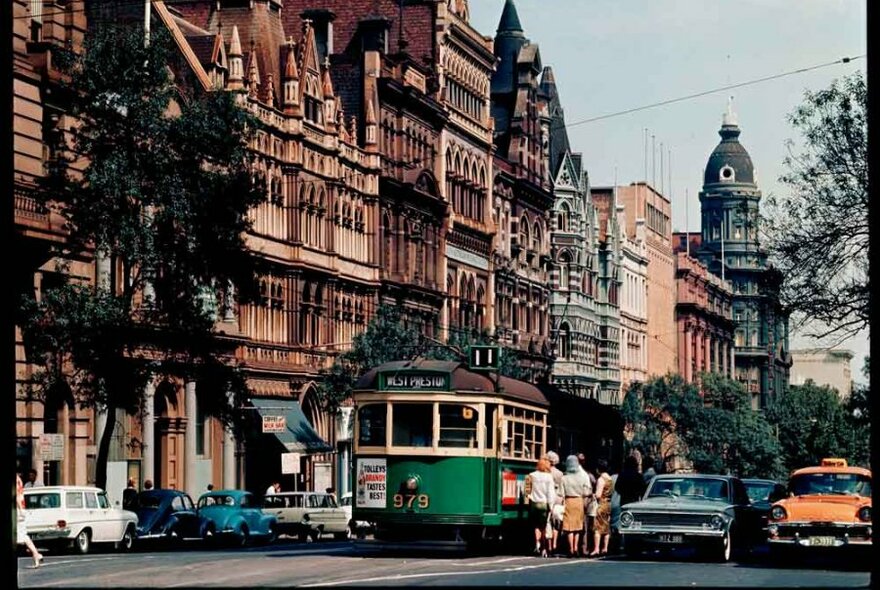 A vintage photo of a tram on a city street.