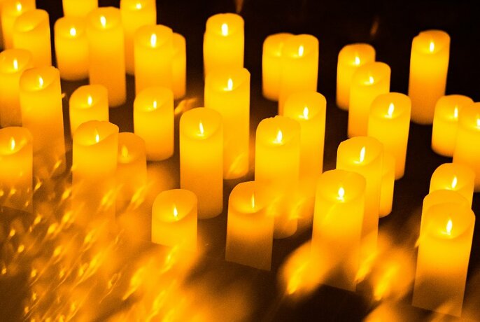 A group of glowing yellow candles.