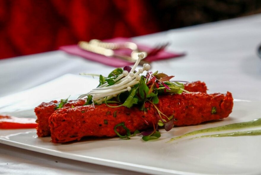 An Indian dish, Lamb Sigar, on a white plate.