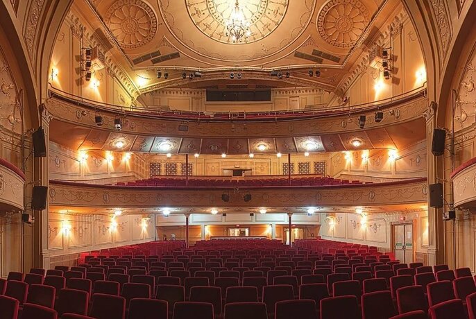 Athenaeum Theatre interior with balconies and tiered seating.