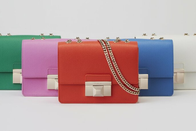 Five identically-styled boxy handbags in different colours. 
