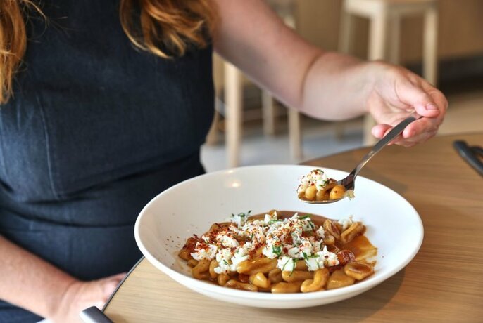 Person eating pasta.