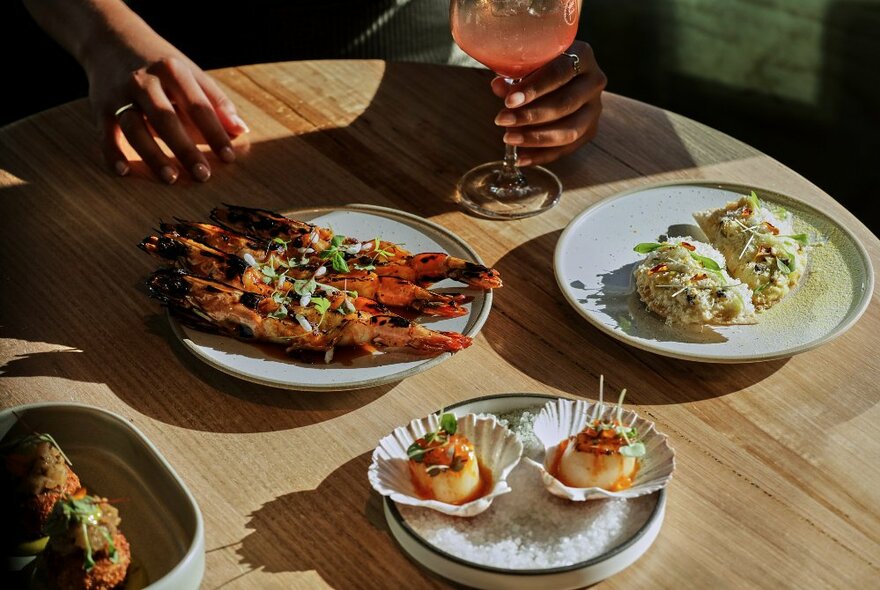 A selection of plates from Fleet Rooftop Bar, including scallops and grilled prawns.