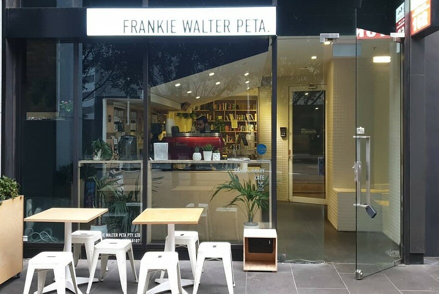 Exterior of Frankie Walter Peta café showing outdoor tables and stools.