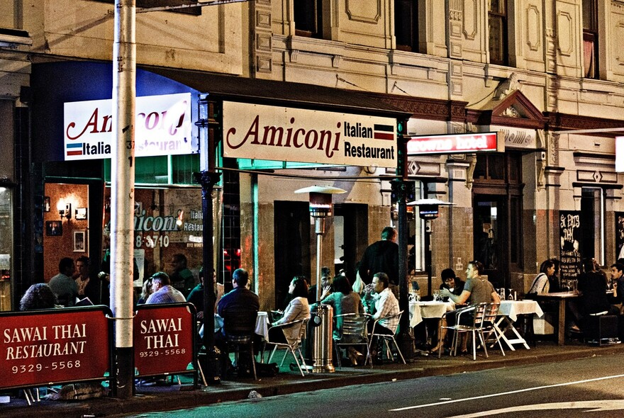 Amiconi Italian restaurant with tables of diners outside.