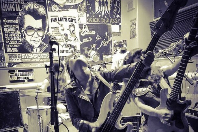 A rock band playing live in a record store.