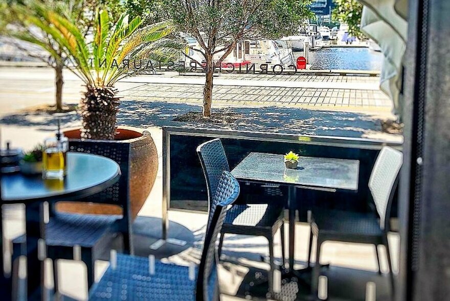 Outdoor tables at Corniche Restaurant exterior.