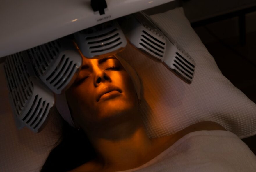 A customer receiving rays from a treatment machine.