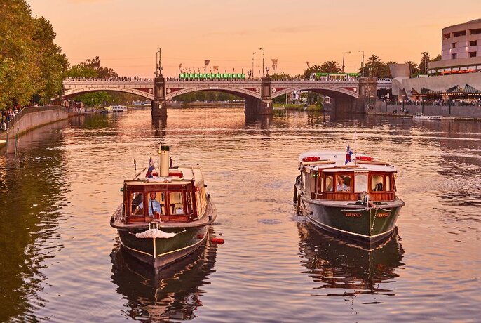 Two boats on the Yarra River, with Prince's Bridge in the background.