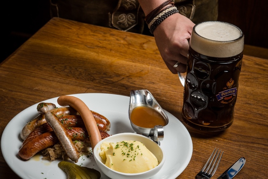 German sausages, mustard and a large, dark-coloured beer.