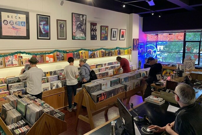 People browsing LPs in a record store.