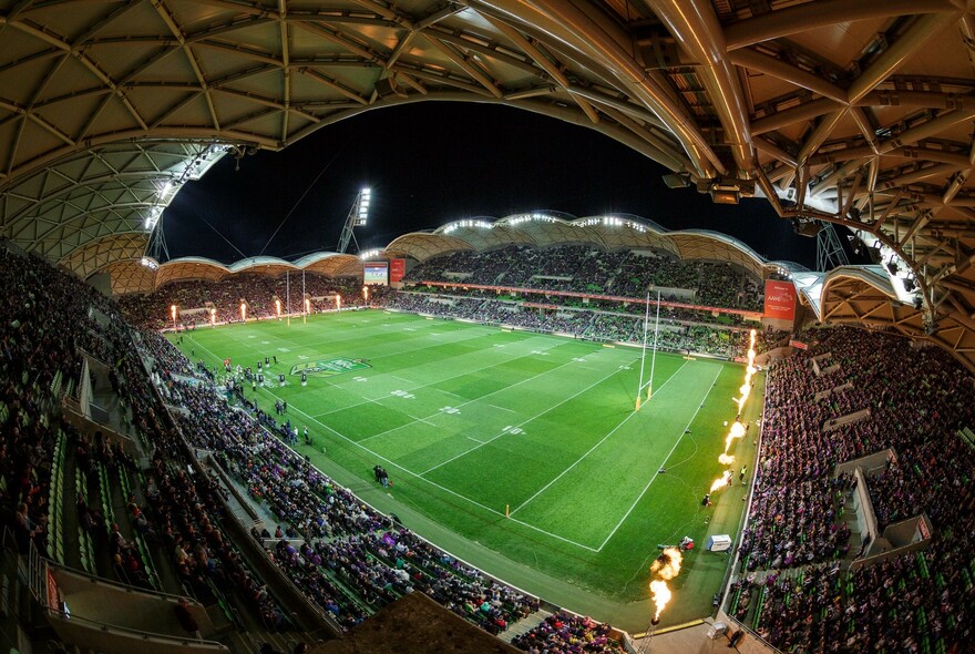 Inside AAMI Park stadium showing domed roofed, spectator seating and sports pitch.