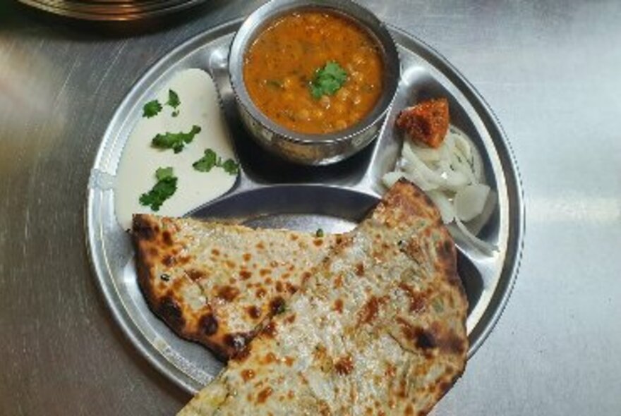 Indian dahl, onions, yoghurt and naan bread.