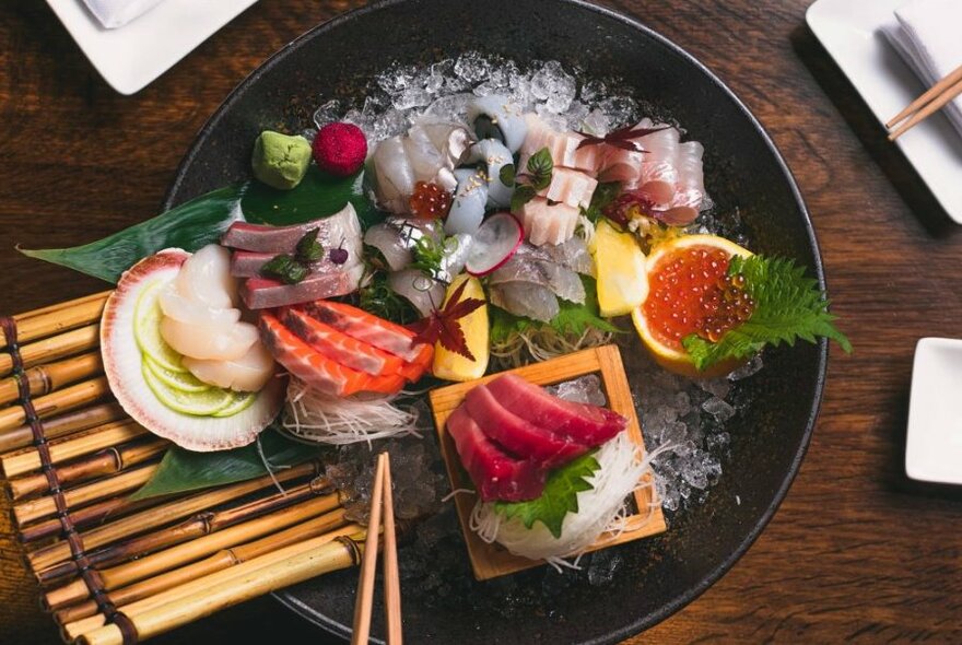 Large round platter of Japanese sashimi.