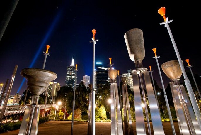 Night view of the Federation brass bells, perched atop metal upright supports.
