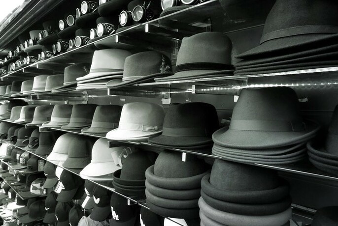 Rows of men's hats in a hat shop.