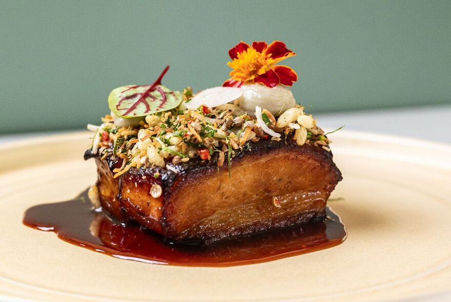 A delicious-looking pork-belly dish with a rich brown sauce, and Vietnamese slaw on the top. 