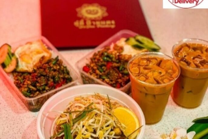 Thai food and drinks in takeaway containers.