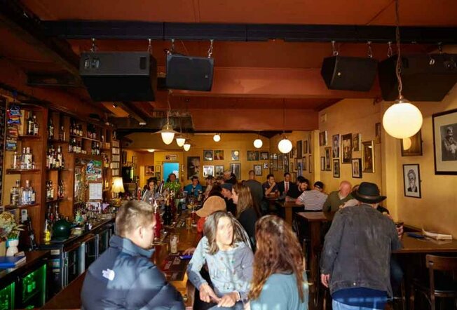 People drinking in a crowded Irish pub