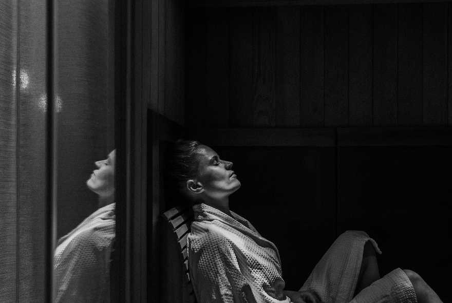 Person relaxing in sauna.