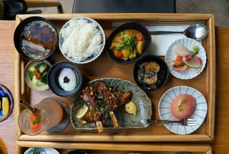 A wooden board filled with Japanese food