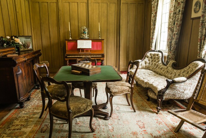 Antique chaise longue and other period furniture inside La Trobe's Cottage.