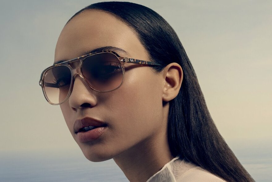 Close-up of a woman modelling designer sunglasses.