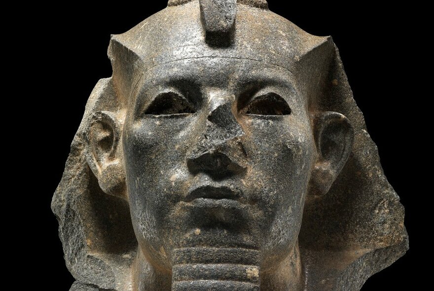 Stone head of colossal statue, Egyptian, dating to about 1800 BC​.