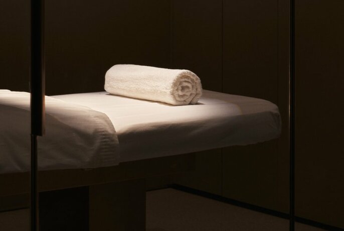 A beauty treatment bed with a towel. 