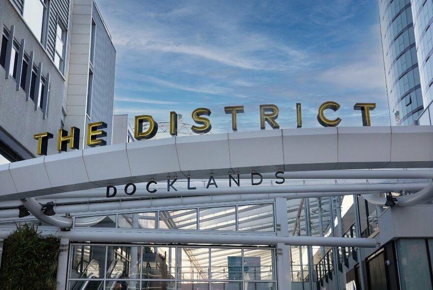 The outside entrance sign of the The District Docklands 