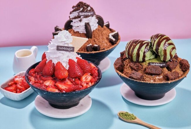 Three bingsu bowls with chocolate being drizzled on top. One is choc mint, one is cookies and cream the other is strawberry. 