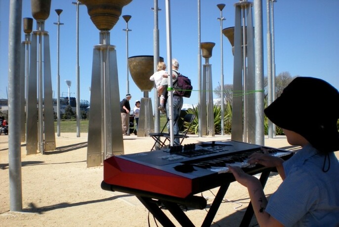 The Federation brass bells during the day, with a child playing an electronic keyboard in the foreground.