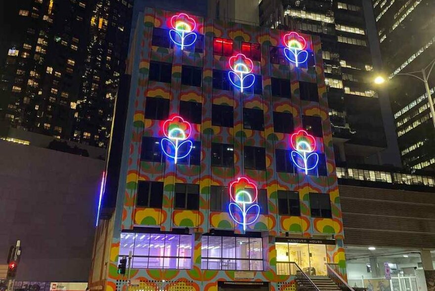 Neon flowers on the side of a building