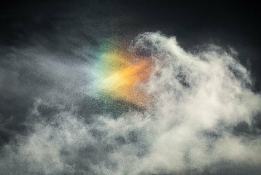 Clouds partially obscuring a triangular-shaped spectrum.