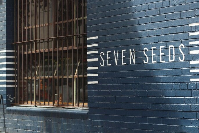 Exterior wall of Seven Seeds café showing their branding.