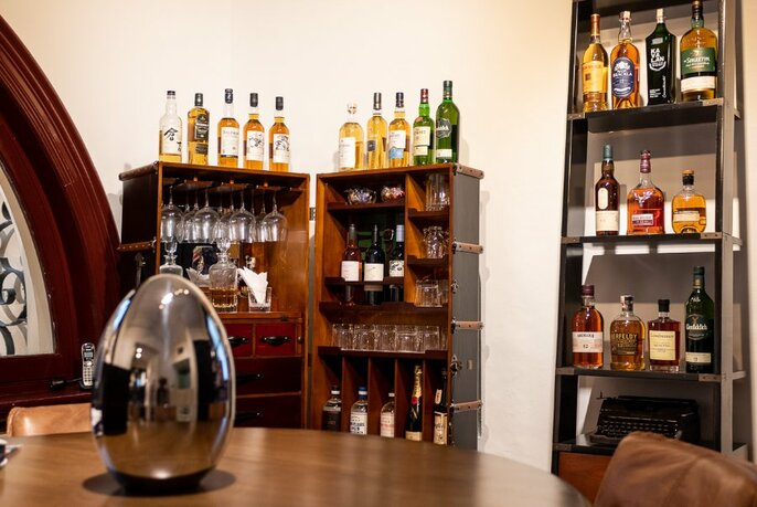 Interior of Truefitt & Hill with shelves displaying bottles of whiskey.