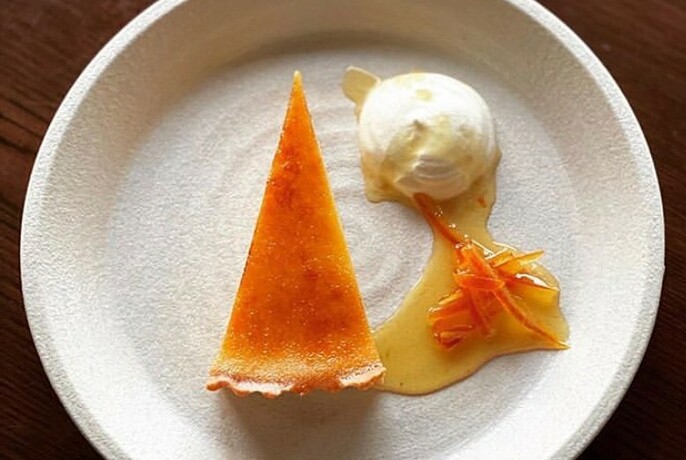 Slice of orange dessert and ice cream.