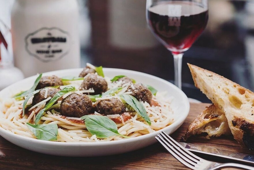 Meatballs and spaghetti and a glass of red wine. 