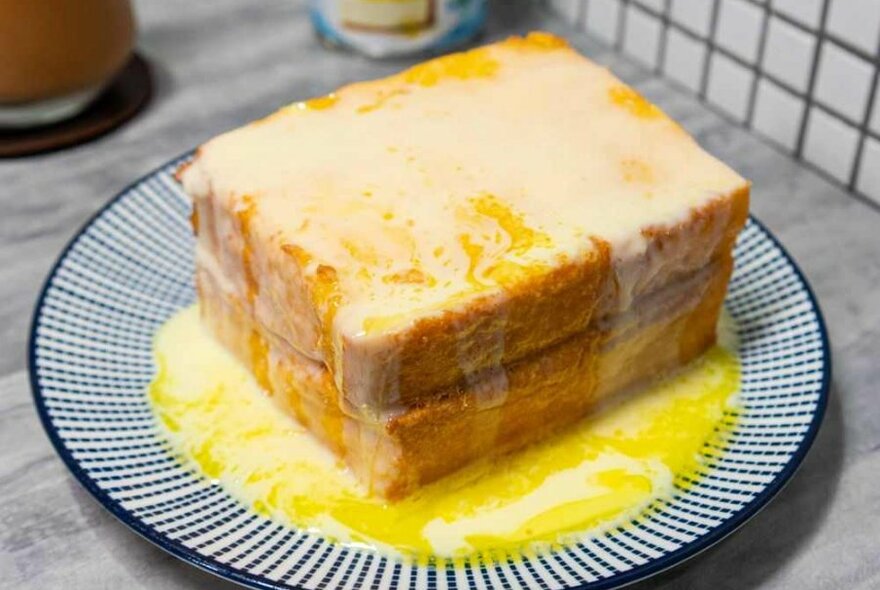 A stack of toast with melted butter on top.