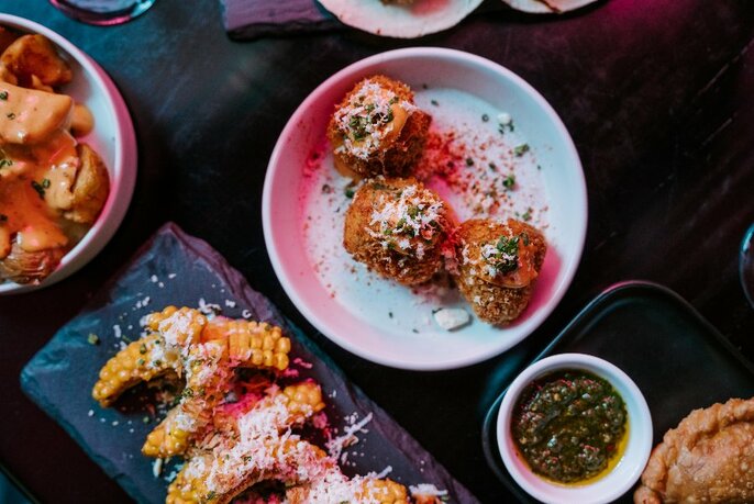 Dishes of bar snacks with dips.