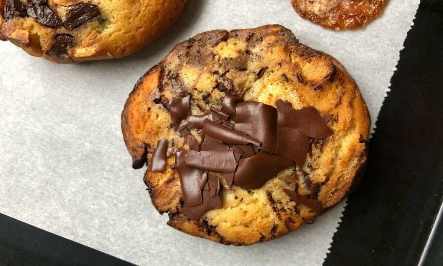 A chocolate chip cookie on a pan
