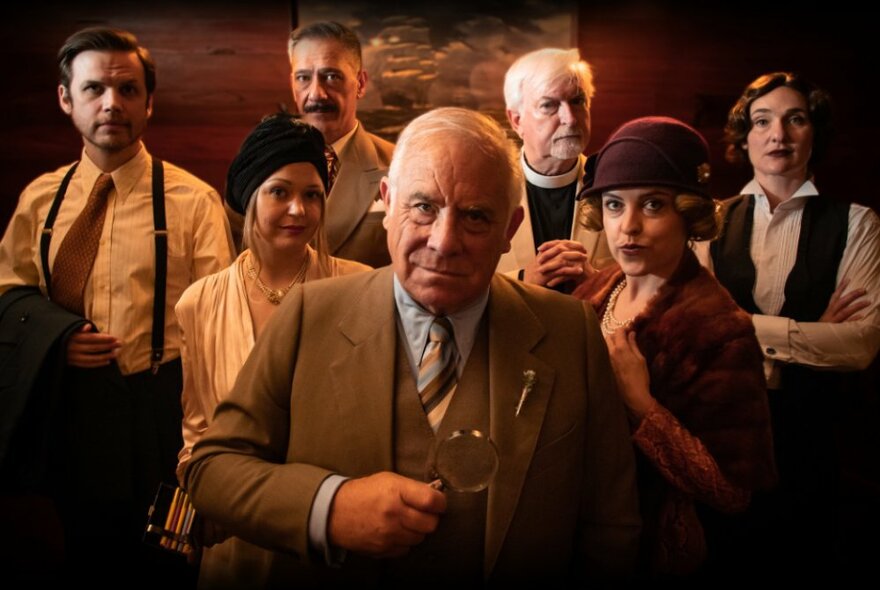 Group of actors dressed in 1920s outfits including a vicar, flapper and detective.