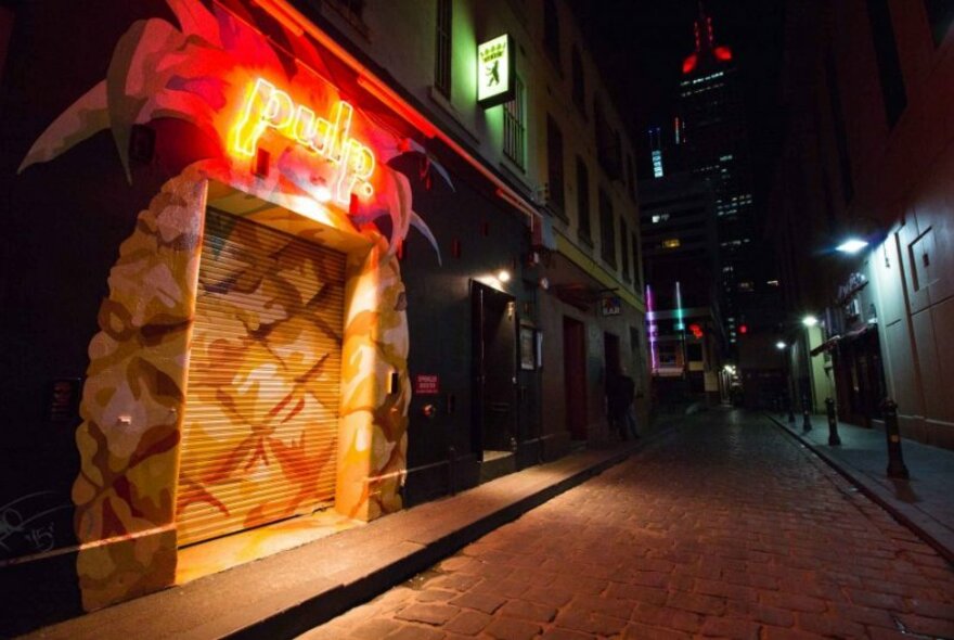 Laneway roller door entrance to Pulp nightclub, painted to resemble a pineapple. 